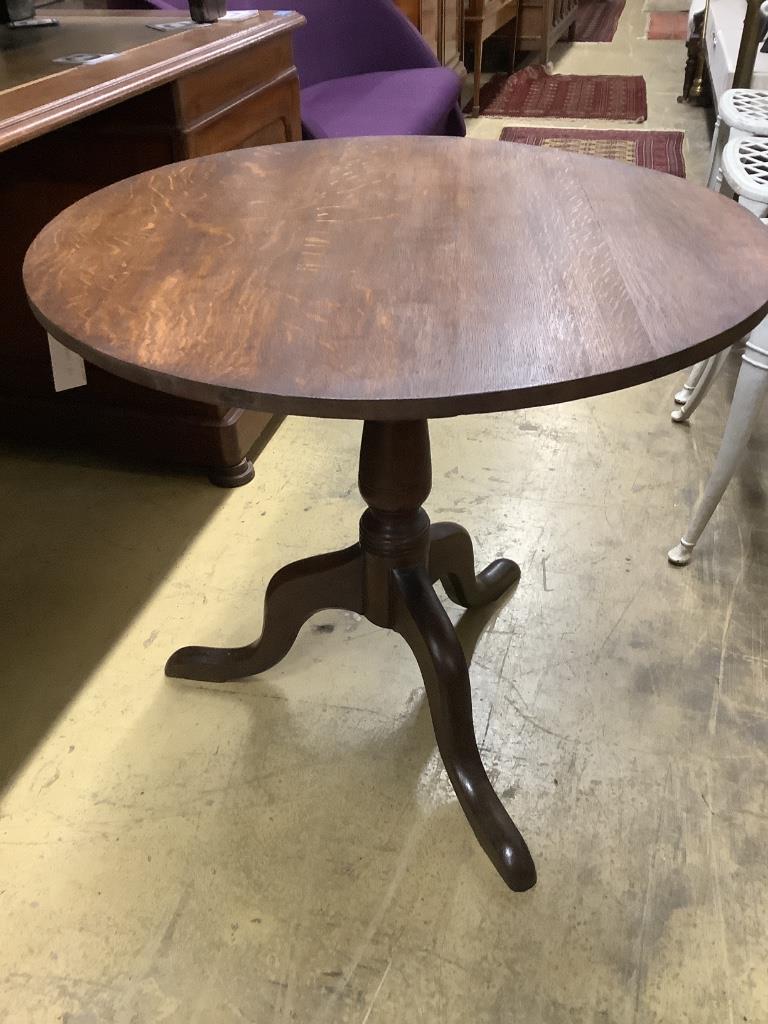 A George III oak circular tilt top tea table, diameter 75cm height 70cm